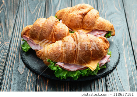 Croissant sandwich with salad ham and cheese . Top view Croissant sandwich with salad ham and cheese . Top view 118637191