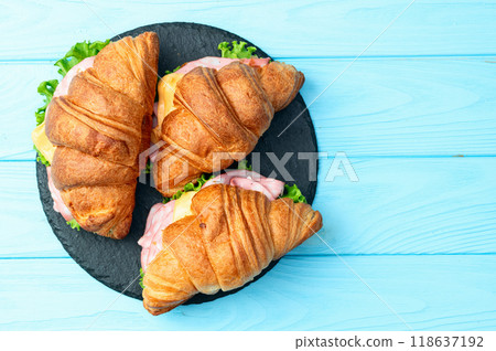 Croissant sandwich with salad ham and cheese . Top view Croissant sandwich with salad ham and cheese . Top view 118637192