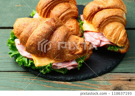 Croissant sandwich with salad ham and cheese . Top view Croissant sandwich with salad ham and cheese . Top view 118637193