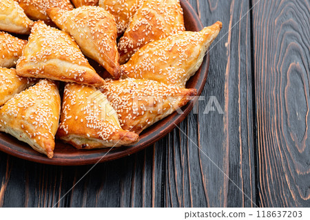 Homemade triangle puff pastry with meat on rustic background . Samosa Homemade triangle puff pastry with meat on rustic background . Samosa 118637203