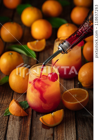 Classic tequila sunrise cocktail on an old wooden table. 118637263