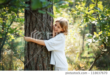 Teenager girl hugging tree. 118637670