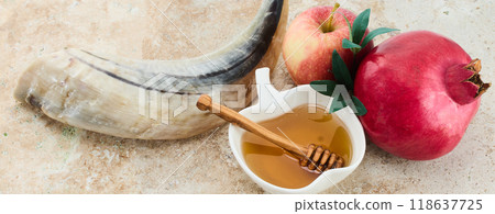 Rosh Hashanah Symbols. Traditional items for Rosh Hashanah shofar, honey, apple, and pomegranate on a rustic background. Rosh Hashanah Symbols. Traditional items for Rosh Hashanah shofar, honey, apple, and pomegranate on a rustic background. 118637725