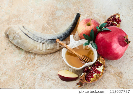 Rosh Hashanah. Traditional items for Rosh Hashanah shofar, honey, apple, and pomegranate on a rustic background. 118637727