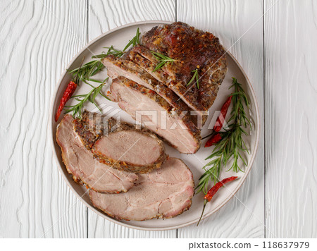 Roast Pork Neck sliced on a plate, top view 118637979