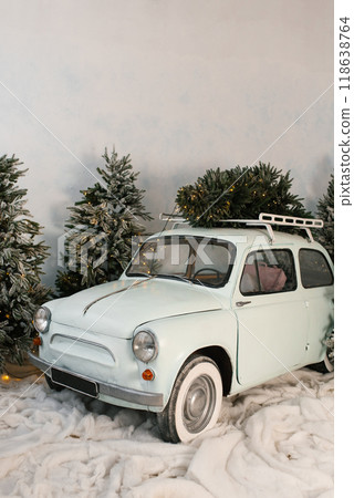 Retro car with a Christmas tree on top of it 118638764