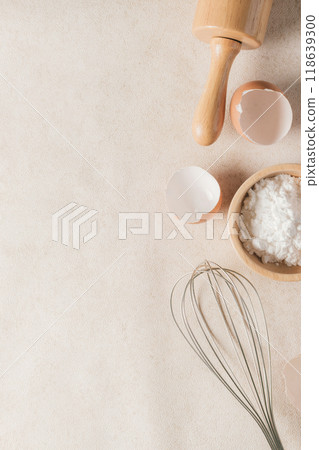 Baking flour and baking supplies placed on a beige tabletop with copy space and vertical photography. 118639300