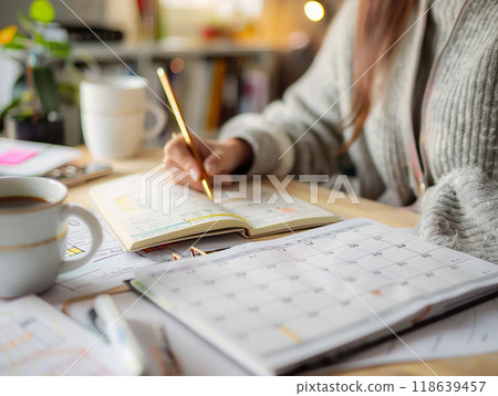 Detailed shot of an individual scheduling their week, calendar and planner for productivity, high resolution, Detailed shot of an individual scheduling their week, calendar and planner for productivity, high resolution, 118639457