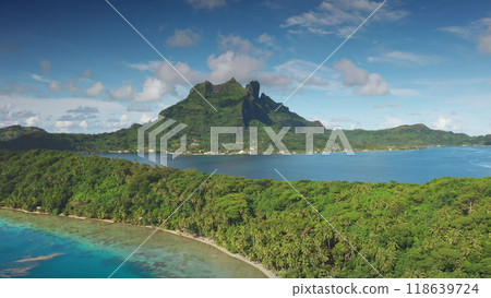 Drone capturing beauty of tropical Bora Bora island with turquoise water lagoon, white sand beach, and lush green mountains. Perfect travel destination for relaxation and adventure. Aerial view shot Drone capturing beauty of tropical Bora Bora island with turquoise water lagoon, white sand beach, and lush green mountains. Perfect travel destination for relaxation and adventure. Aerial view shot 118639724