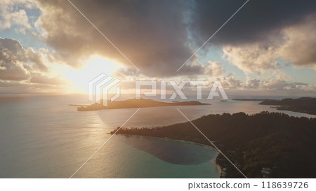 Bora Bora island with turquoise lagoon, mountains and clouds reflecting golden light of amazing colorful sunrise. Tropical island, beautiful landscape of untouched nature. Travel. Aerial drone flight Bora Bora island with turquoise lagoon, mountains and clouds reflecting golden light of amazing colorful sunrise. Tropical island, beautiful landscape of untouched nature. Travel. Aerial drone flight 118639726