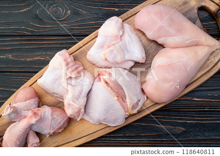Raw mixed chicken meat parts for cooking on rustic background Raw mixed chicken meat parts for cooking on rustic background 118640811