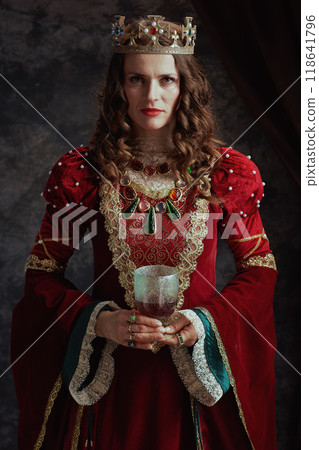 medieval queen in red dress with goblet and crown medieval queen in red dress with goblet and crown 118641796