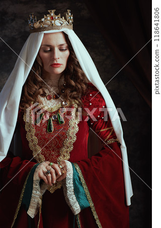 medieval queen in red dress with veil and crown 118641806