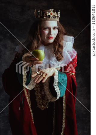 insidious medieval queen in red dress with green apple 118641813