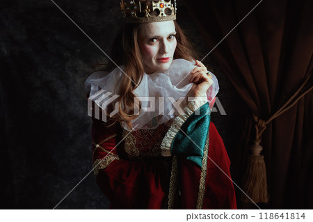 medieval queen in red dress with white collar and crown 118641814