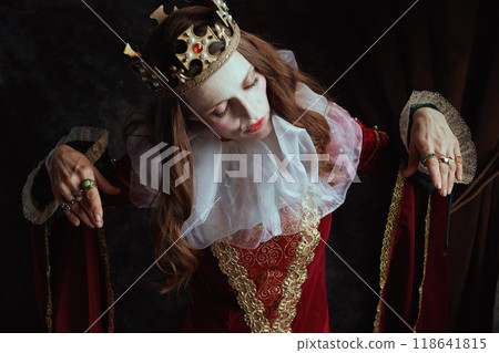 scary medieval queen in red dress with white collar and crown scary medieval queen in red dress with white collar and crown 118641815
