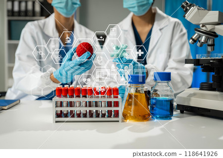 Chemist scientist holding test tube and tablet conducting experiment in laboratory with equipment, science concept. 118641926