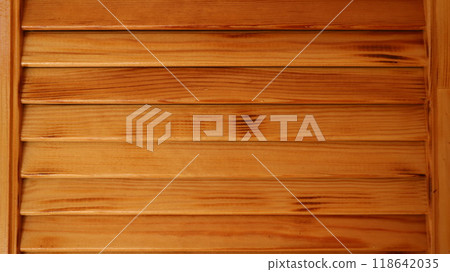fragment of wooden paneling made of horizontal and vertical planks in the structure of a building or interior, varnished boards of natural wood as a textured background fragment of wooden paneling made of horizontal and vertical planks in the structure of a building or interior, varnished boards of natural wood as a textured background 118642035