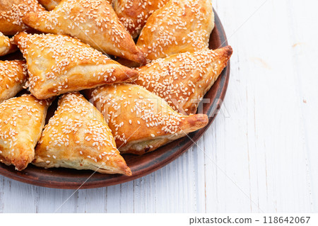 Homemade triangle puff pastry with meat on rustic background . Samosa Homemade triangle puff pastry with meat on rustic background . Samosa 118642067