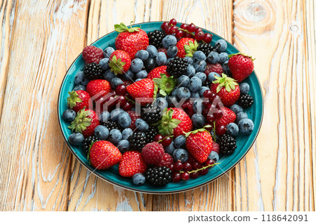 Mix of ripe colorful berries in bowl photography . Blueberry , strawberry , raspberry , blackberry and red currant . Top view Mix of ripe colorful berries in bowl photography . Blueberry , strawberry , raspberry , blackberry and red currant . Top view 118642091