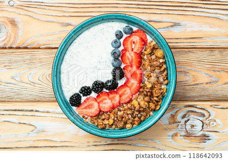 Healthy breakfast . Yogurt with berries ( strawberry , raspberry , blueberry , blackberry ) , granola and chia seeds . Top view 118642093