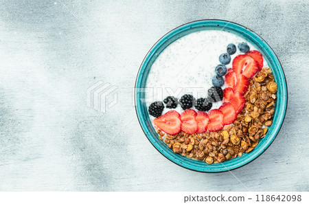 Healthy breakfast . Yogurt with berries ( strawberry , raspberry , blueberry , blackberry ) , granola and chia seeds . Top view 118642098