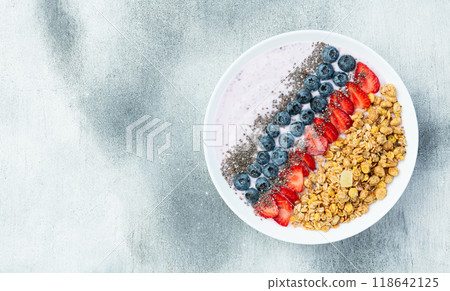 Healthy breakfast . Yogurt with berries ( strawberry , raspberry , blueberry , blackberry ) , granola and chia seeds . Top view 118642125
