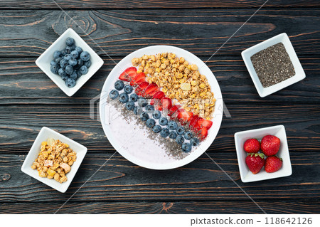 Healthy breakfast . Yogurt with berries ( strawberry , raspberry , blueberry , blackberry ) , granola and chia seeds . Top view 118642126