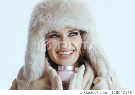 happy woman in winter coat and fur hat on white 118642178