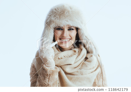 smiling stylish woman in winter coat and fur hat on white smiling stylish woman in winter coat and fur hat on white 118642179