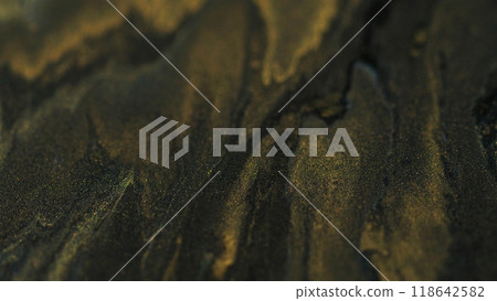 Glitter paint. Ink background. Defocused sparkling liquid flow acrylic gold black shimmering blend mystical abstract emulsion art texture. 118642582