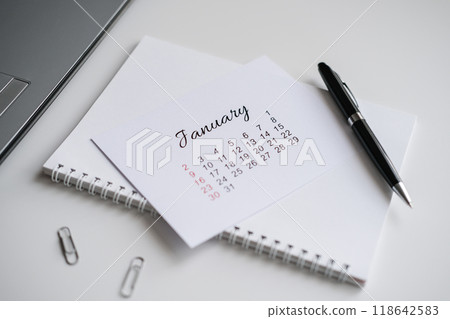 January calendar page on office desk January calendar page on office desk 118642583