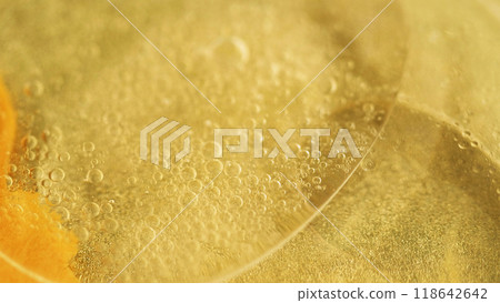 Oil bubbles. Golden ink. Defocused yellow color translucent sparkling paint shiny sequin particles gel flow motion abstract art background. Oil bubbles. Golden ink. Defocused yellow color translucent sparkling paint shiny sequin particles gel flow motion abstract art background. 118642642