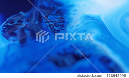 Paint flow. Liquid spill. Defocused blue color glowing acrylic emulsion texture blend pouring wave abstract art background. Paint flow. Liquid spill. Defocused blue color glowing acrylic emulsion texture blend pouring wave abstract art background. 118642996