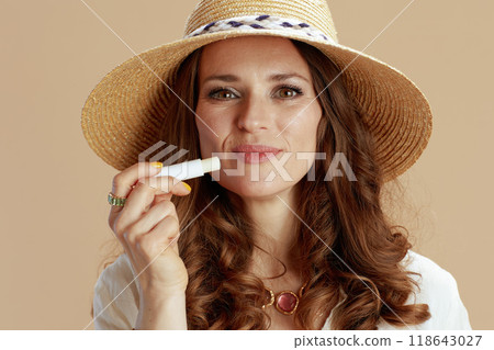 happy trendy woman in blouse and shorts on beige 118643027