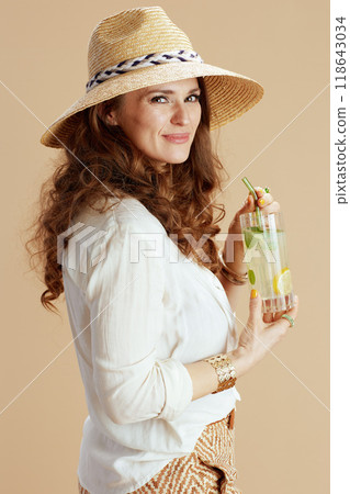 happy elegant housewife in blouse and shorts against beige 118643034