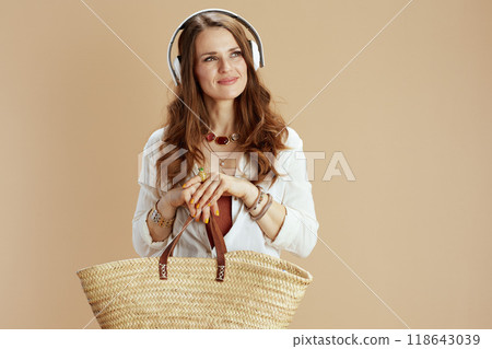 smiling elegant woman in blouse and shorts isolated on beige smiling elegant woman in blouse and shorts isolated on beige 118643039