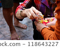 During the Songkran festival, people participate in a water pouring ceremony for monks to show their respect. 118643227