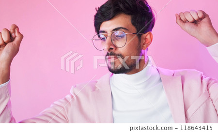 Winner dance. Victory inspiration. Neon light relaxed satisfied business man in glasses suit celebrating success isolated on pink copy space background. 118643415