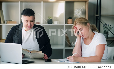 Office teamwork. Explain meeting. Tired woman with overweight colleague discussing business task sharing ideas information on briefing training. 118643663
