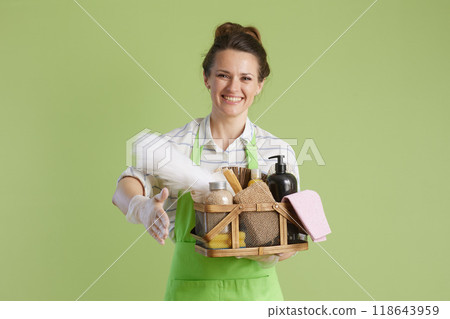 happy housewife giving hand for handshake against green happy housewife giving hand for handshake against green 118643959