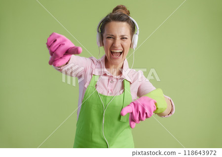 smiling modern woman pointing in camera on green background smiling modern woman pointing in camera on green background 118643972