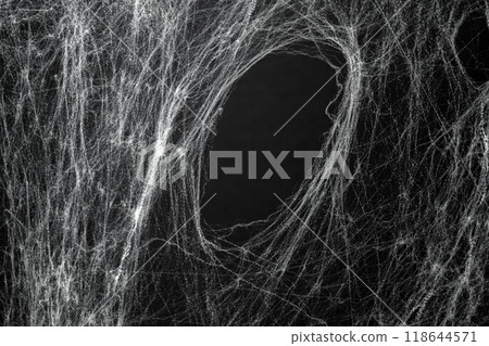 Spooky creepy cobweb spiders web covered a black background. Abstract halloween background. 118644571