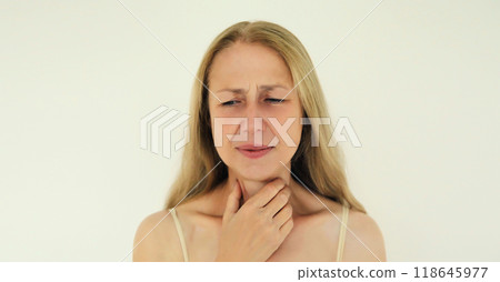 Sick exhausted woman suffering from acute sore in throat flu, touches neck with hand Sick exhausted woman suffering from acute sore in throat flu, touches neck with hand 118645977