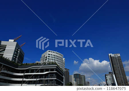 Cityscape near Tosabori Bridge in Nakanoshima, Osaka: Skyscrapers towering above a clear blue sky 118647075