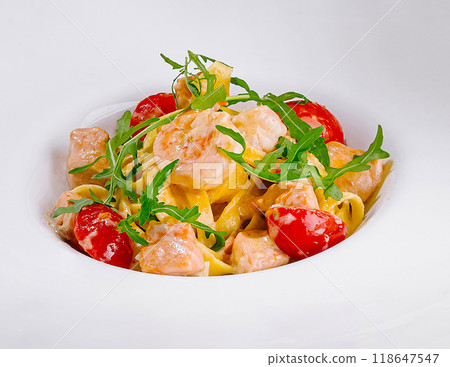 Two plates of shrimp noodles with tomatoes and greens 118647547