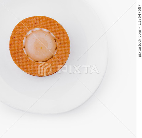 Minimalist orange sphere on textured mat 118647687