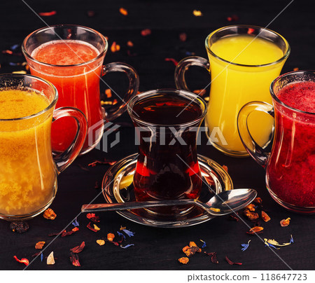 Steaming tea and fruit infusions warming up a cold winter day Steaming tea and fruit infusions warming up a cold winter day 118647723