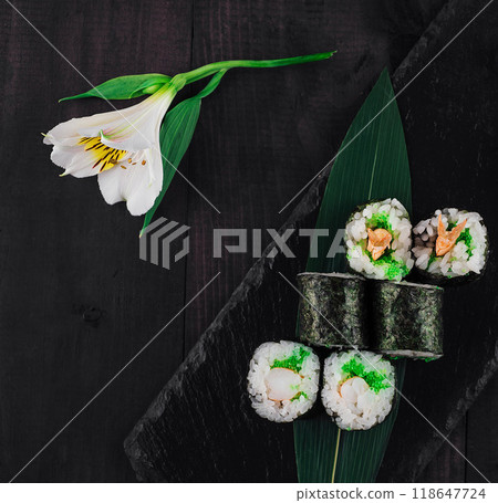 Sushi rolls set served on black stone with ginger and wasabi Sushi rolls set served on black stone with ginger and wasabi 118647724