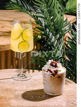 Two refreshing drinks with ice are standing on a table in a tropical cafe Two refreshing drinks with ice are standing on a table in a tropical cafe 118647739